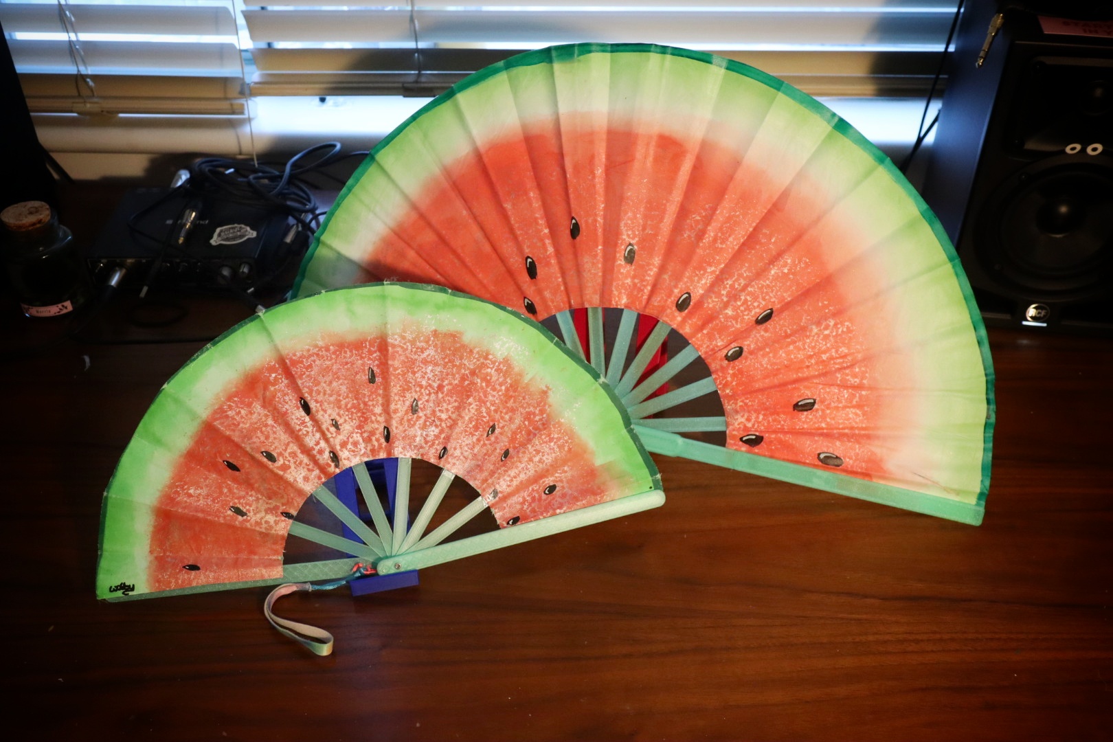 Painted watermelon fan on a green frame